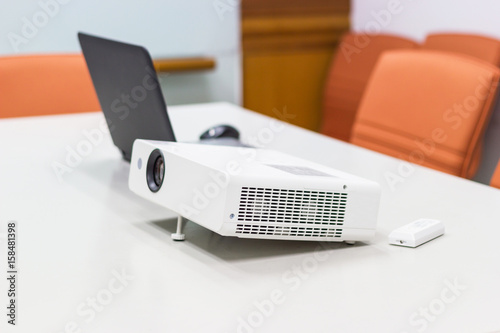 projector connected to Laptop on for presentation in a meeting room