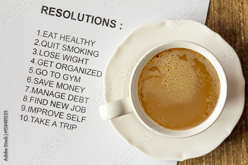 Cup of cappuccino with list of new resolutions