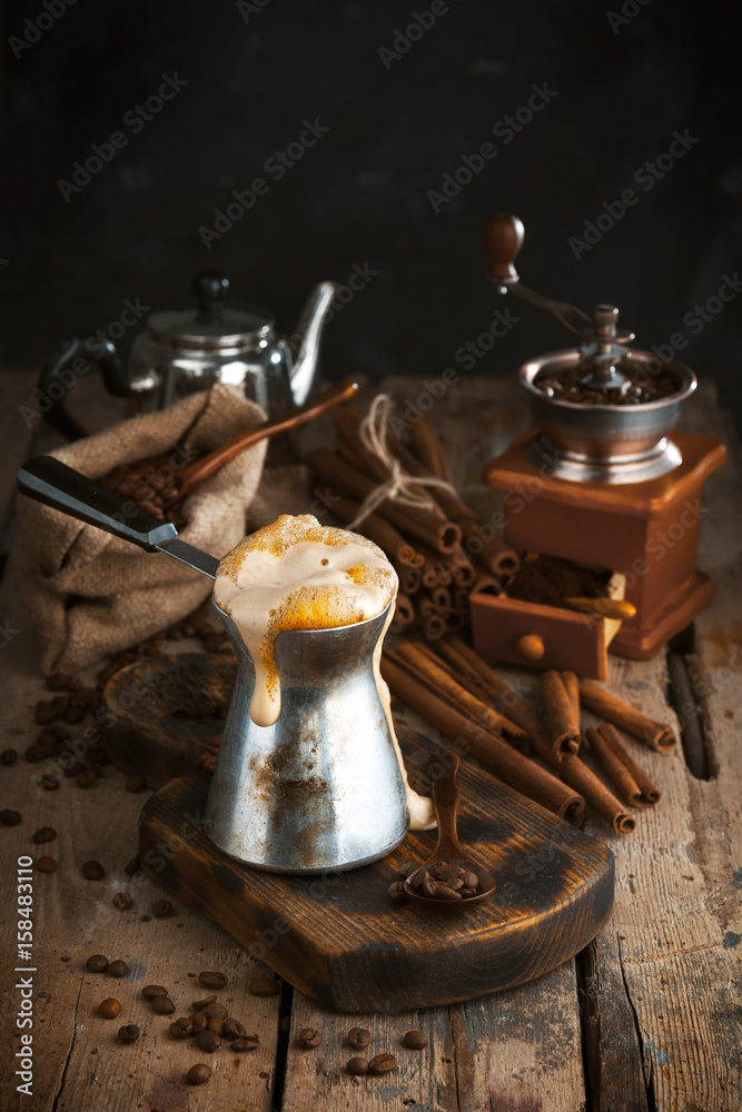 Turk, including freshly brewed coffee, a sack of coffee beans, vintage coffee grinder, cinnamon sticks. Turk, including freshly brewed coffee, a sack of coffee beans, vintage coffee grinder, cinnamon sticks.