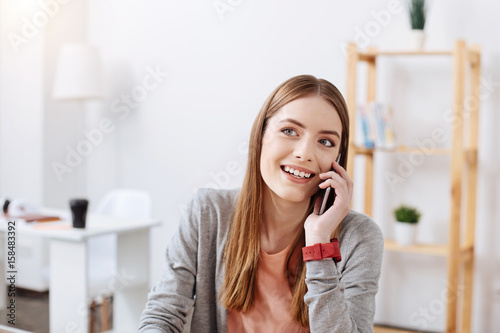 Lively gorgeous girl chatting on the phone