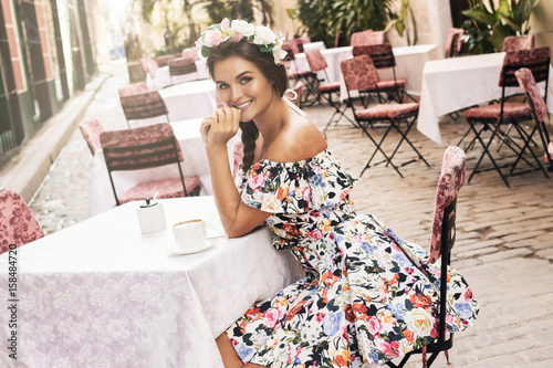 Photography Smiling woman sitting in the stree cafe