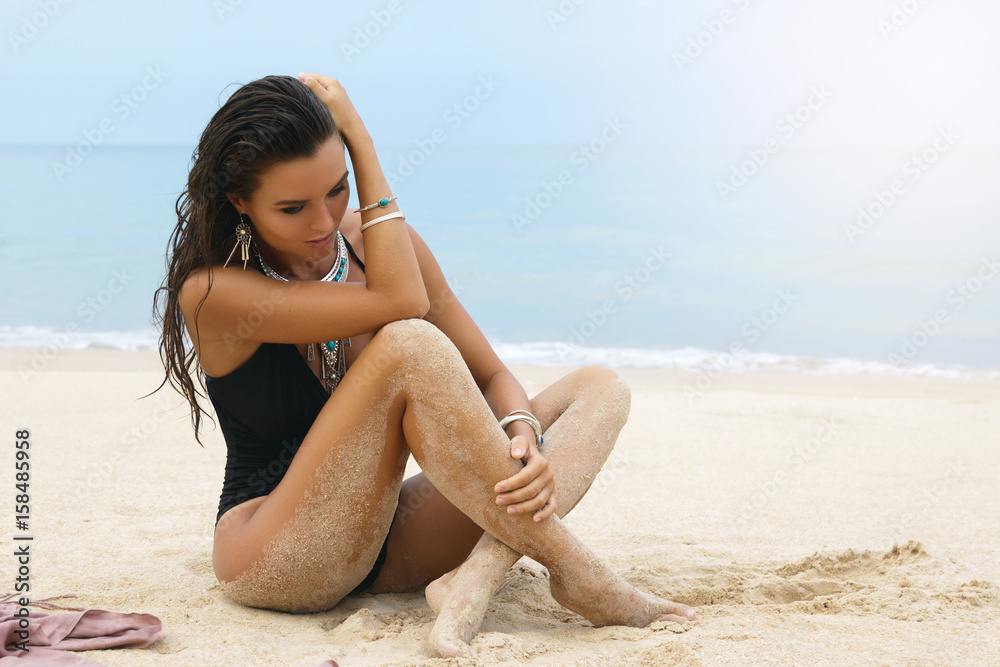 Woman wearing silver jewelry on the beach