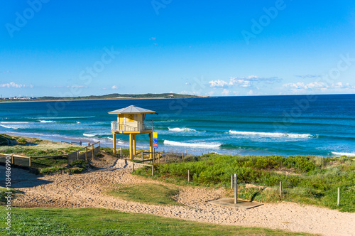 Beach landscape with rescue tower and beautiful ocean view photo