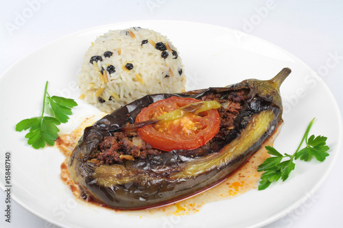 Turkish cuisine. Karniyarik and rice pilaf with dried black corinth raisin. Eggplant stuffed ground meat.