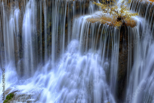 Close up waterfall at Huay Mae Kamin Waterfall, beautiful waterfall in autumn forest and wood pier , Kanchanaburi province, Thailand .