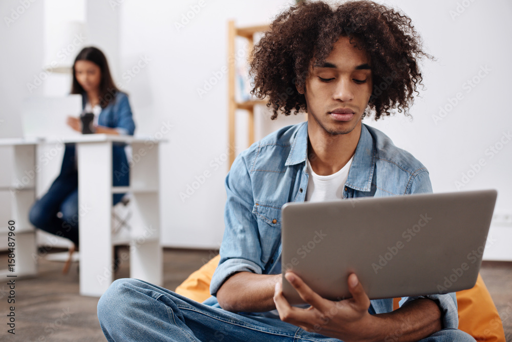 Nice committed man typing a letter on his laptop Nice committed man typing a letter on his laptop
