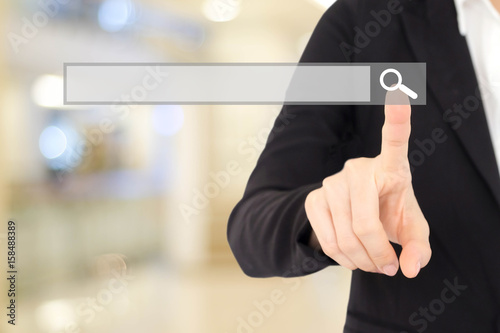 Businesswoman hand touching blank search bar over blur background, business and technology concept, search engine optimization, web banner
