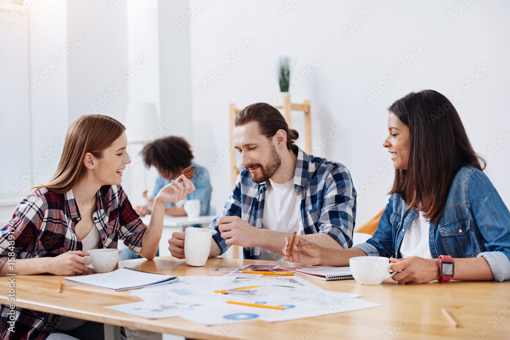 Bright productive colleagues having a tasty lunch break Bright productive colleagues having a tasty lunch break