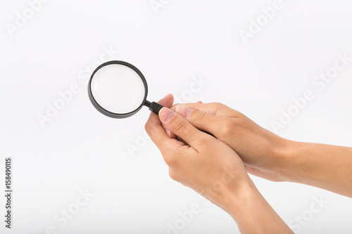 Female hands on white background with magnifier