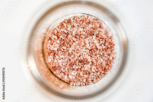 Himalaya salt in glass vessel isolated.