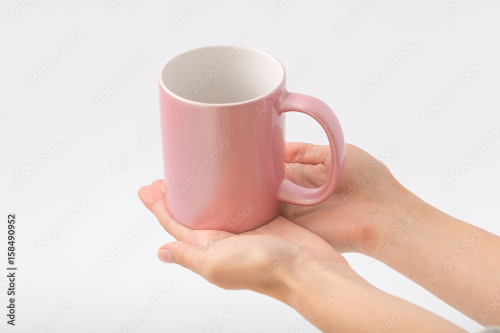 Obraz premium Female hands on a white background with a cup