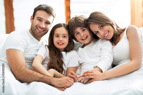 Smiling family in bed 