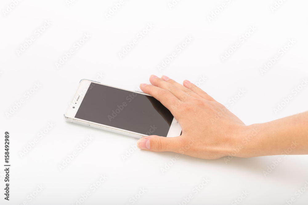 Female hands on a white background with a phone. Female hands on a white background with a phone.