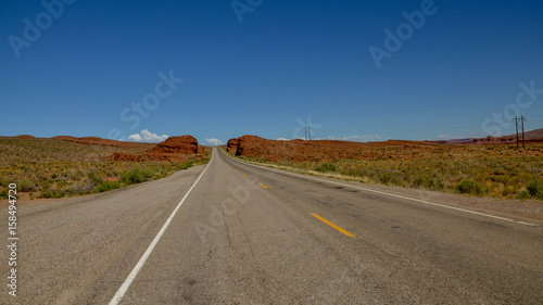 empty road in desert between Arizona and Utah U.S. Route 163 National Scenic Byway, Mexican Hat, San Juan County, Utah, United States