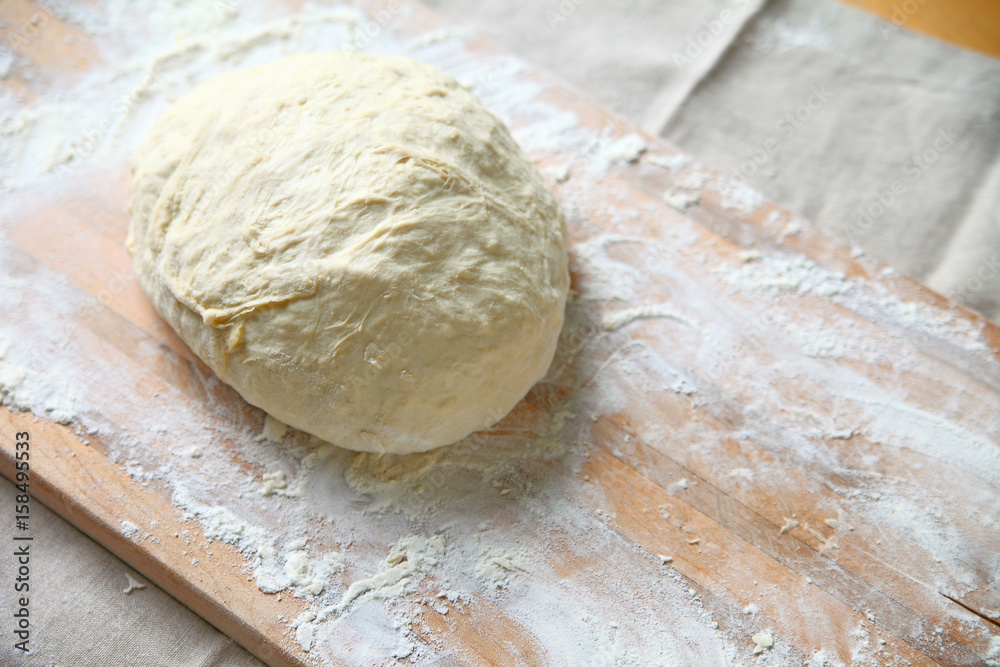 Yeast dough on a floured cutting board after kneading Yeast dough on a floured cutting board after kneading
