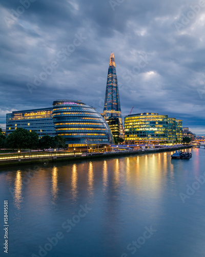 View of London's city hall and modern skyscrapers at night