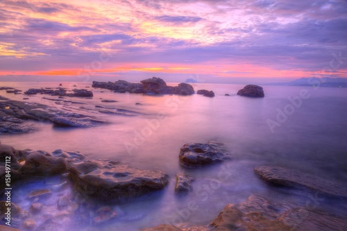 Dramatic dawning sky reflecting on peaceful sea water at the rocky beach of Yilan Coast Geologic Park in northeast Taiwan ~ Beautiful sunrise scenery of a rocky coast in rosy twilight (Long Exposure) © AaronPlayStation