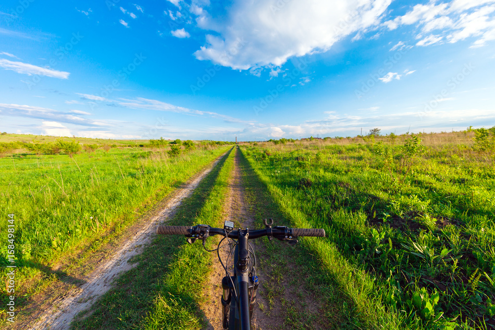 Mountain biking down hill descending fast on bicycle. View from bikers eyes. Mountain biking down hill descending fast on bicycle. View from bikers eyes.