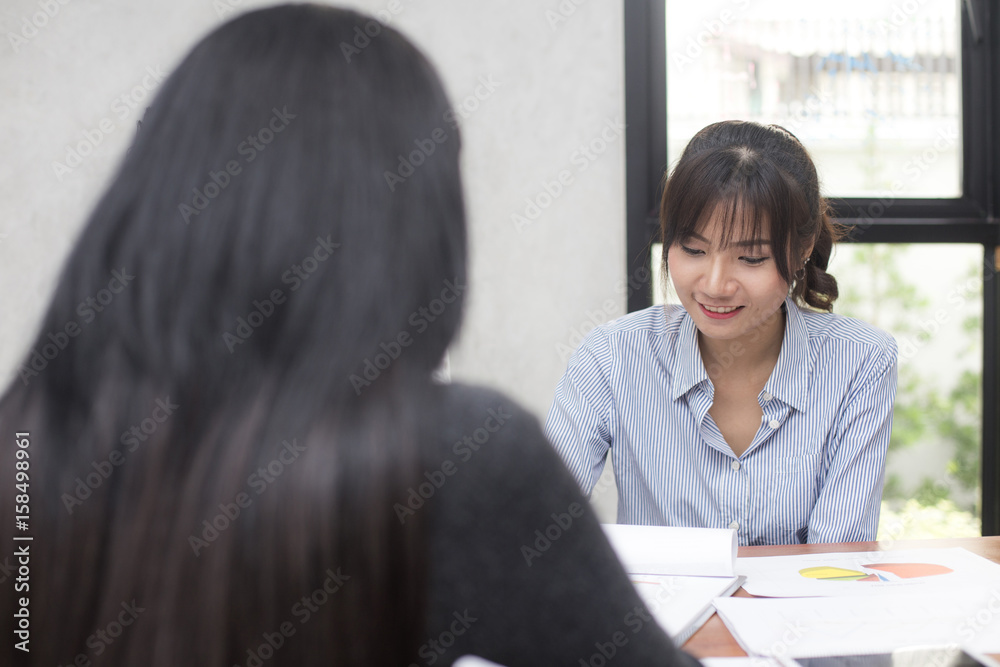 Young Asian woman arriving for a job interview. Business people takling in modern office. Greeting deal concept Young Asian woman arriving for a job interview. Business people takling in modern office. Greeting deal concept
