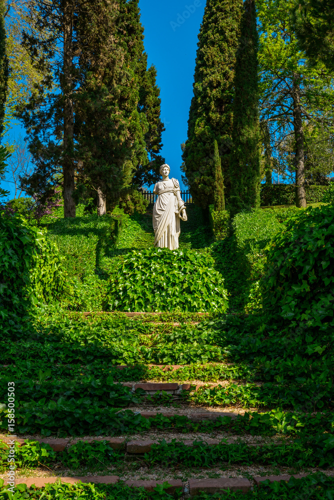 Staircase covered with ivy  and sculpture