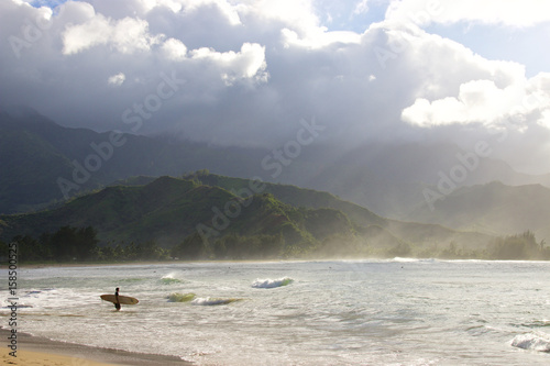 Surfer at Hanalei Bay on the Hawaiian Island of Kauai