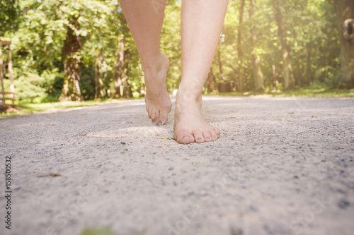 Female barefoot legs walking in nature