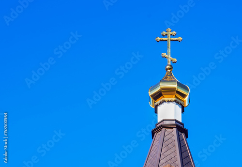 Golden cross on the dome of the temple. photo