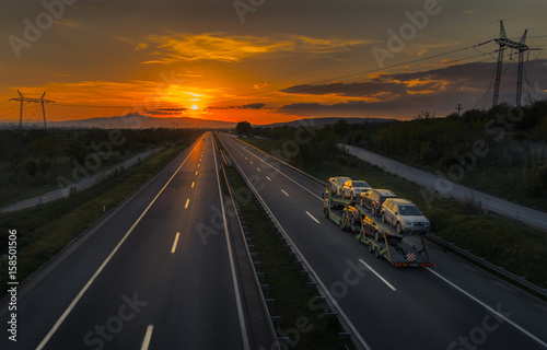 Auto Transporter Truck on a Sunset Road