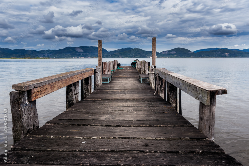Fototapeta premium Old wood pier at Lago di Massaciuccoli