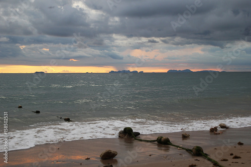 Travel to island Koh Lanta, Thailand. The view on the sand beach and cloudy sky at the sunset.