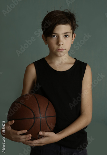 teenager boy with basketball ball close up portrai