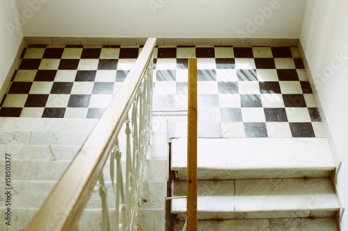 Φωτογραφία Old stairs, wooden banister and chess floor