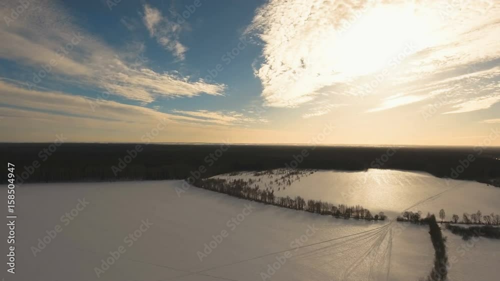 The field covered with snow in a winter season. Aerial view: Winter landscape countryside, forest, field. Winter landscape, field, forest, trees covered with frost snow Aerial footage 4K video The field covered with snow in a winter season. Aerial view: Winter landscape countryside, forest, field. Winter landscape, field, forest, trees covered with frost snow Aerial footage 4K video
