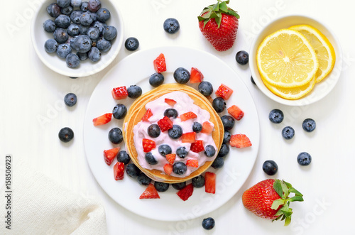 Pancakes with fruit yogurt, fresh strawberry and blueberry