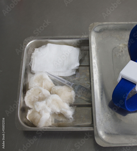 sterile tray with cotton wool and syringe