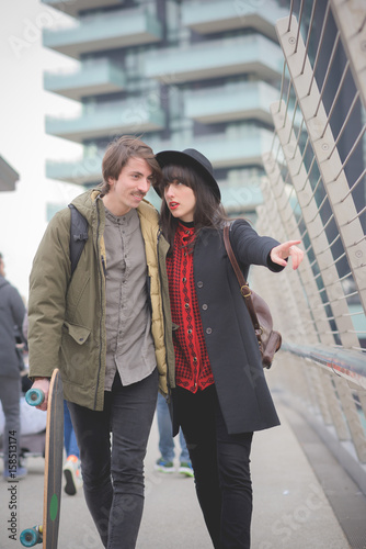 Couple of young beautiful caucasian woman and man with moustache.