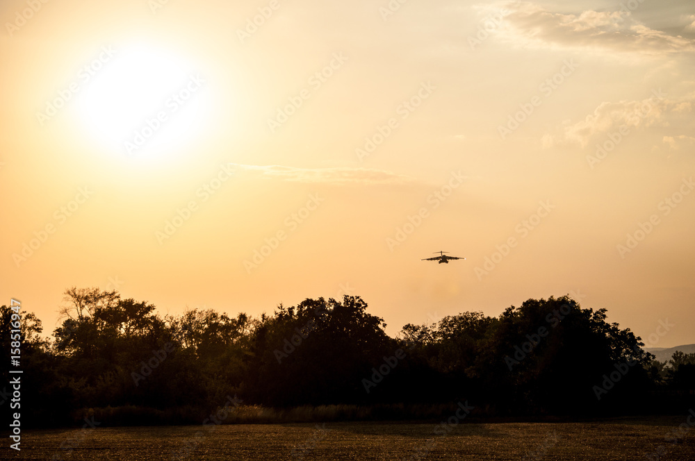 Landing large airliner at sunset (Brno Airport, Czech Republic) Landing large airliner at sunset (Brno Airport, Czech Republic)