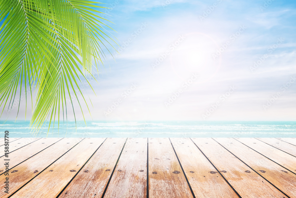 Empty wooden table and palm leaves with party on beach blurred background in summer time. Empty wooden table and palm leaves with party on beach blurred background in summer time.