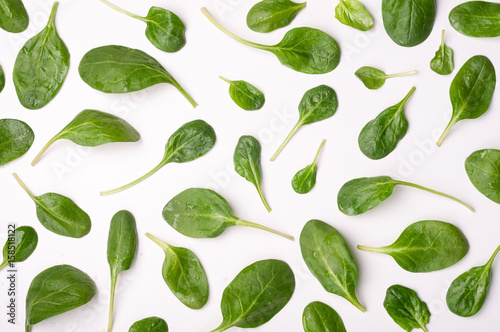 Spinach leaves on white background. Pattern of spinach leaf isolated background. Creative food concept. Ingredient for salad. Flat lay, top view