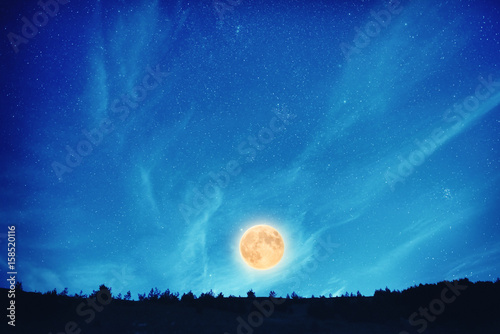 Full moon at night on the dark blue sky