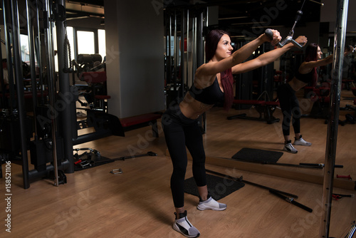 Attractive Woman Doing Heavy Weight Exercise For Back