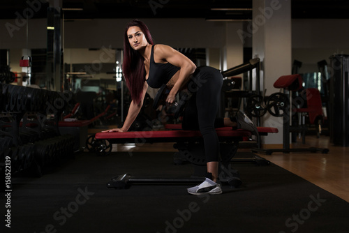 Beautiful Woman Exercising Back With Dumbbells