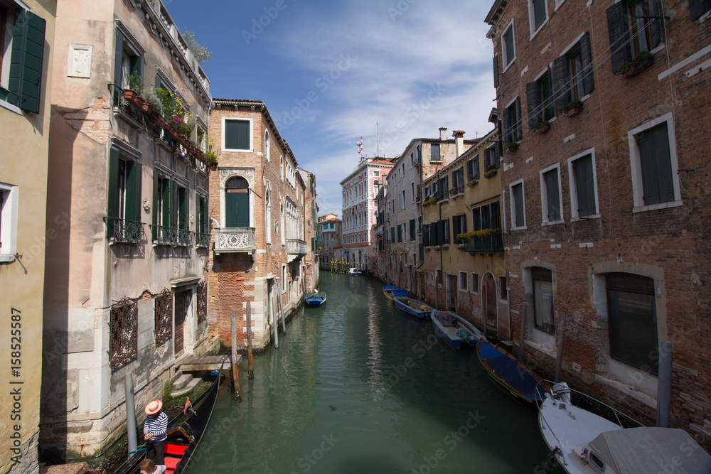 Old buildings in a Venice canal with boats parking along the buildings