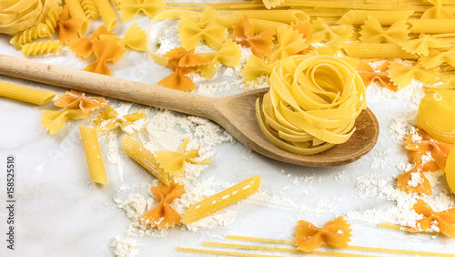 Pappardelle, penne, fusilli, and farfalle pasta with copyspace