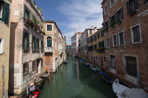 Old buildings in a Venice canal with boats parking along the buildings