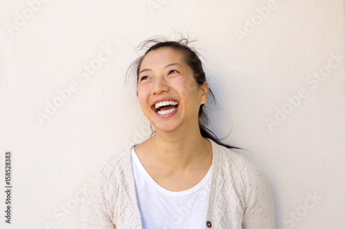 Fotografie Close up asian woman smiling against by  white wall
