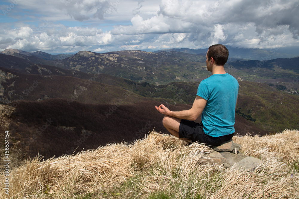 Naklejka premium Meditating on a mountain