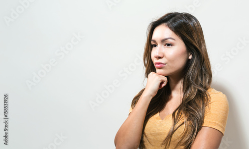 Young woman in a thoughtful pose
