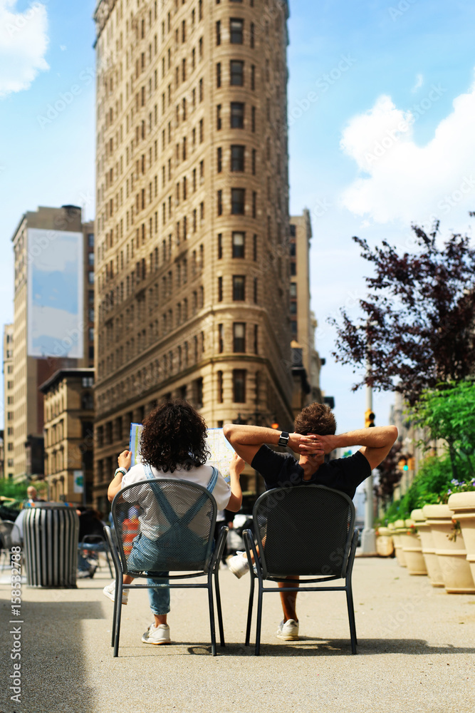 Tourists sit on chairs in a Park in new York