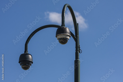 Surveillance CCTV security cameras on blue sky background